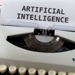 Image of computer screen with Artificial Intelligence written on it in big print.